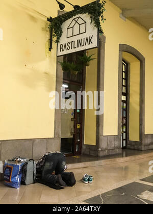 Muslim faithful praying on a platform at Ljubljana railway station, Ljubljana, Slovenia Stock Photo