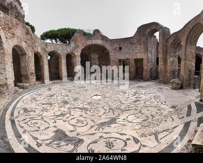 Immersive panoramic view of the circular hall of the seven wise thermal baths in archaeological excavation of Ostia Antica, with the beautiful polychr Stock Photo