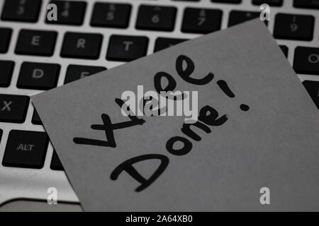 Writing on sticky note Well done! Text with Well done! on paper. Sticky note on keyboard. Stock Photo