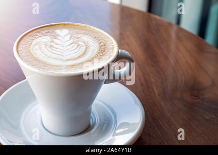 Fresh cappuchino or flat white coffee in a white cup with latte art Stock Photo