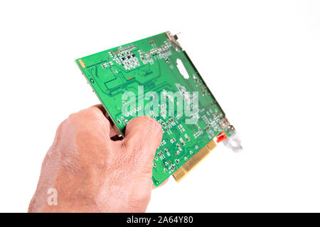 Left hand giving circuit board against white background closeup Stock Photo