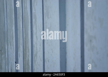 Background image made up of a close up of a modern ribbed concrete wall with repeating vertical patterns and a flat concrete texture Stock Photo