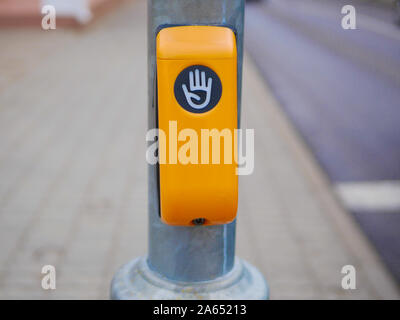 button to cross the street. Yellow button to safely cross the street on an iron pole Stock Photo