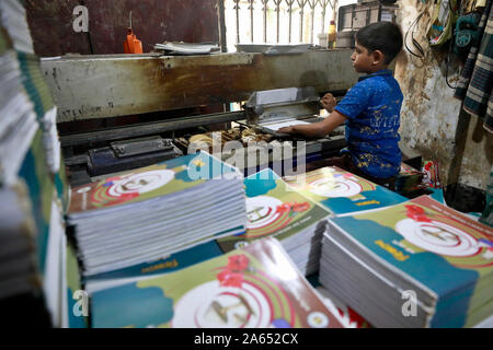 Dhaka, Bangladesh - October 22, 2019. Bangladeshi book binding worker working in a printing house at bangla bazar in Dhaka, Bangladesh. Stock Photo