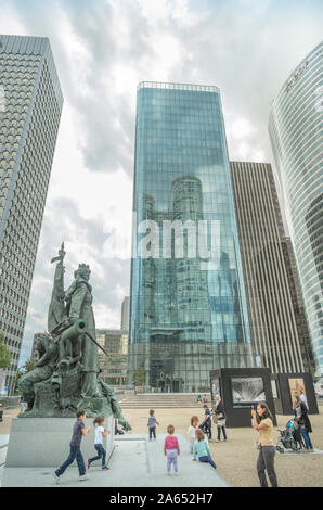 sculpture la defense de paris with high-rise office towers in background