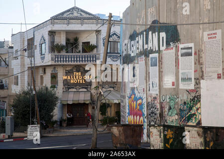 West Bank, Bethlehem: The Walled off Hotel overlooking the wall that separates Israel and Palestine. Hotel open in 2017 by artist Bansky Stock Photo