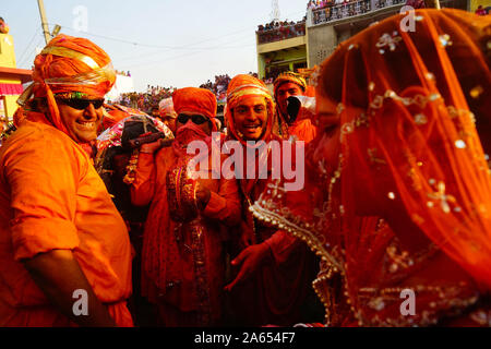 Men teasing women, Lathmar Holi festival, Mathura, Uttar Pradesh, India, Asia Stock Photo