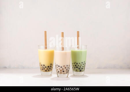 Various Bubble Tea in glasses with drink straws on white background Stock Photo