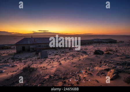 Sunrise above the abandoned houses of Kolmanskop ghost town, Namibia. Stock Photo