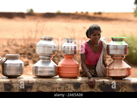 Women waiting for water tanker at dry well, Mall village, Thane Maharashtra, India, Asia Stock Photo