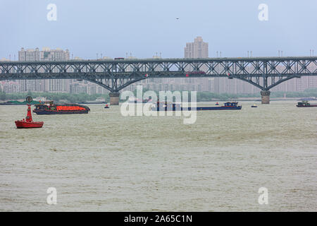 Editorial: NANJING, JIANGSU, CHINA, April 14, 2019 - Boats passing under the Yangtze river bridge in Nanjing Stock Photo