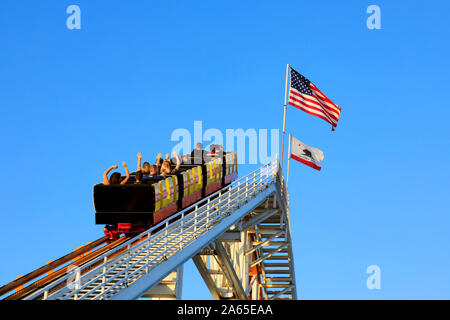 Carriages full of people on the Roller Coaster, Santa Monica Pier, Pacific Park, Los Angeles, California, United States of America. October 2019 Stock Photo