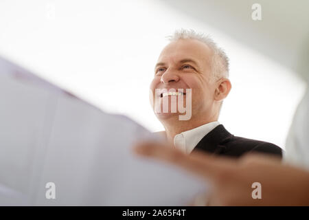 Teamwork With Architect Looking At Plans During Meeting Stock Photo