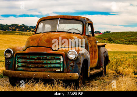 Vintage truck rusted in field Stock Photo