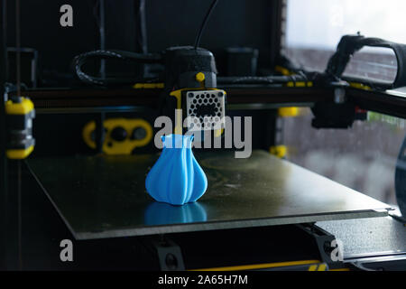 Modern 3d printer with printed three dimentional model of vase. Stock Photo