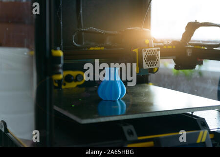 Modern 3d printer with printed three dimentional model of vase. Stock Photo