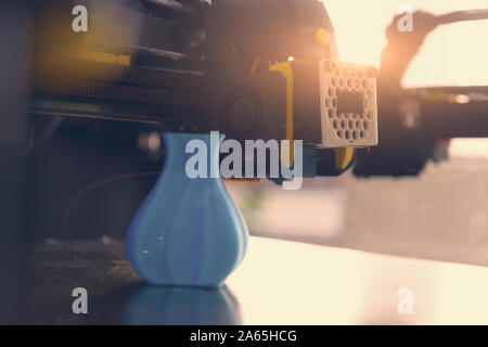 Modern 3d printer with printed three dimentional model of vase. Stock Photo