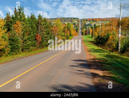Asphalt road running through the countryside during the fall in Prince Edward Island, Canada. Stock Photo