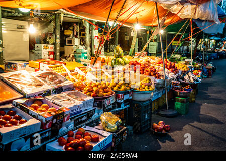 Jeonju Korea , 6 October 2019 : Fruits stall at Nambu traditional market at night in Jeonju South Korea Stock Photo