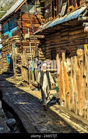 Kashmiri old man walking in street Sheikhpura Chorwan village, Kashmir, India, Asia Stock Photo