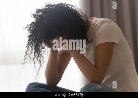 Upset black woman crying suffering from relationships problems Stock Photo