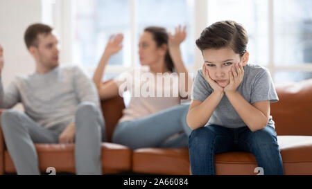 Worried upset small son hurt by parents conflict. Stock Photo