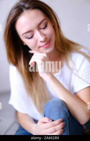 Young european woman wearing white t shirt and jeans. Stock Photo