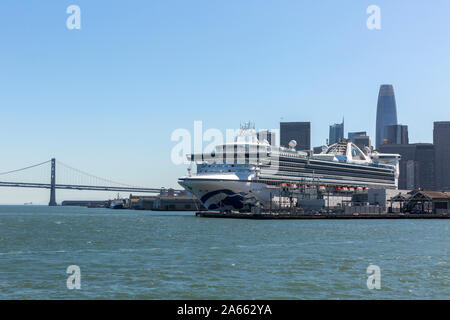 SAN FRANCISCO, USA - OCTOBER 2, 2019:  The Star Princess cruise ship docked in San Francisco harbour with the city skyline and Bay Bridge behind. Stock Photo