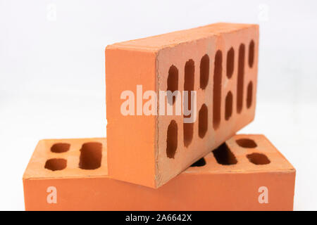 Reddish bricks of perforated building construction and face view Stock Photo