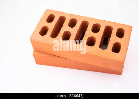 Reddish bricks for the construction of buildings and other works, very resistant and perforated for greater insulation Stock Photo