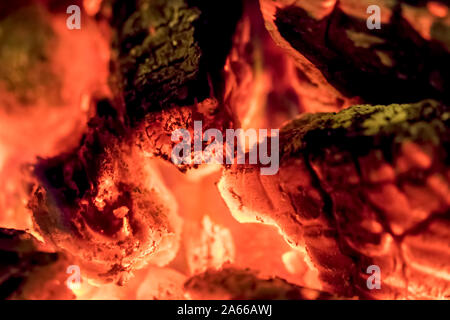 Carbon emission tax. Burning wood embers in close-up. Abstract background image of a wood-burning home fire. Stock Photo
