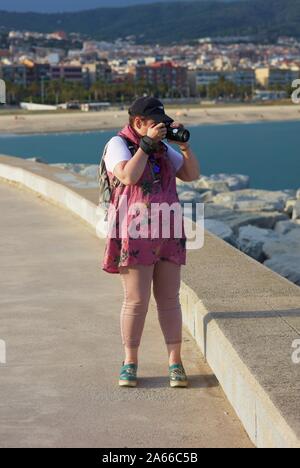 Tourist taking pictures with SLR camera Stock Photo