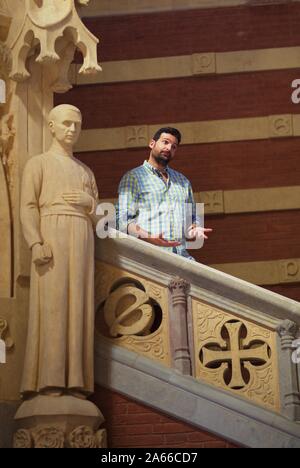 Man posing on stairs inside Recinte Modernista de Sant Pau, Barcelona Stock Photo