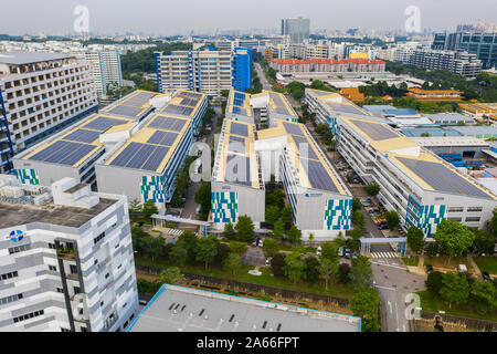 Aerial view of Solar panels on the roof of factories at the industry park. Singapore. Stock Photo