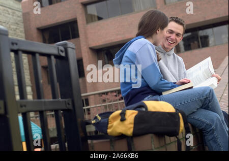 College students hanging out outside of class with textbooks and backpack Stock Photo
