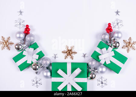 Christmas or winter composition. Pattern made of gift boxes, white balls and snowflakes on white background. Christmas, winter, new year concept. Flat Stock Photo