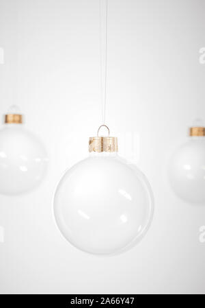 Glass Christmas baubles hanging on white background for winter holiday greeting card. Design Template with Copy Space. Stock Photo