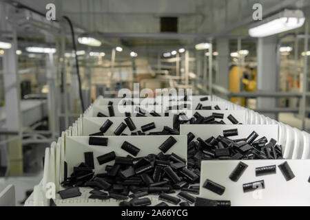 sliced fruit pastilles move on the conveyor of a confectionery factory against a blurry workshop background Stock Photo