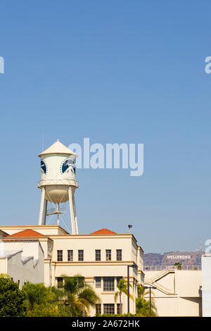 Paramount Picture studios water tower, with the Hollywood sign in the background. Los Angeles, California, United States of America. October 2019 Stock Photo