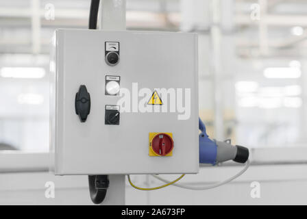 control unit of some production line or machine on a blurred background of the interior of the workshop Stock Photo