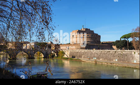 Fortress Sant'Angelo with bronze statue of Michael the Archangel on top and pedestrian bridge, viewed from the other side of the river Tiber in Rome. Stock Photo