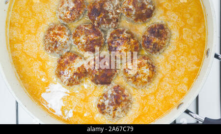 Meatballs in sour cream sauce on a frying pan close up directly from above Stock Photo