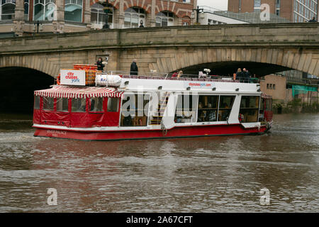 Tourists enjoy an Autumn pleasure boat trip along the River Ouse in York, northern England. Stock Photo