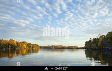 Panorama of a lake in northern Minnesota with clouds and blue on a bright morning during autumn Stock Photo