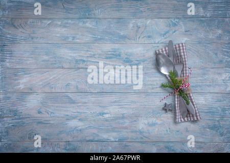 Christmas table place setting with linen napkin, toys and fir tree branch, holidays celebration at the seaside concept Stock Photo