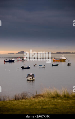 Bamburgh Castle in the distance viewed from Lindisfarne harbour Stock Photo