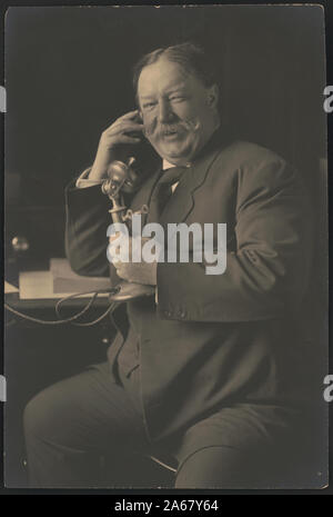 William Howard Taft, three-quarter-length portrait, seated, facing front, smiling while talking on a telephone as he receives news of his nomination as the 1908 Republican presidential candidate from President Theodore Roosevelt] / Harris & Ewing, Washington, DC Stock Photo
