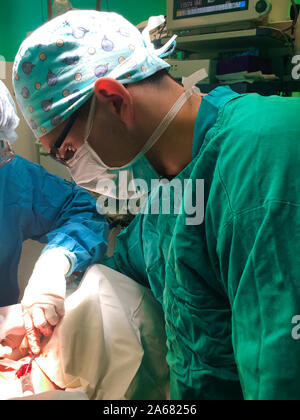 Focused surgeon in glases on the operation Stock Photo