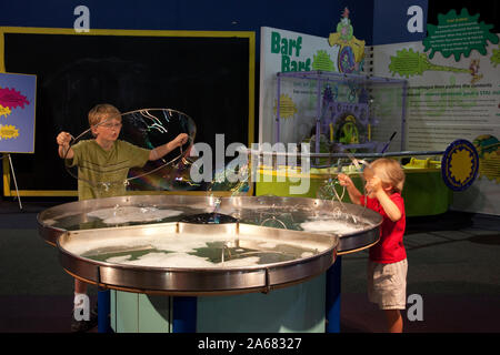 William and Drew Clark blow bubbles at Sci-Quest, Huntsville, Alabama Stock Photo