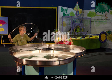 William and Drew Clark blow bubbles at Sci-Quest, Huntsville, Alabama Stock Photo